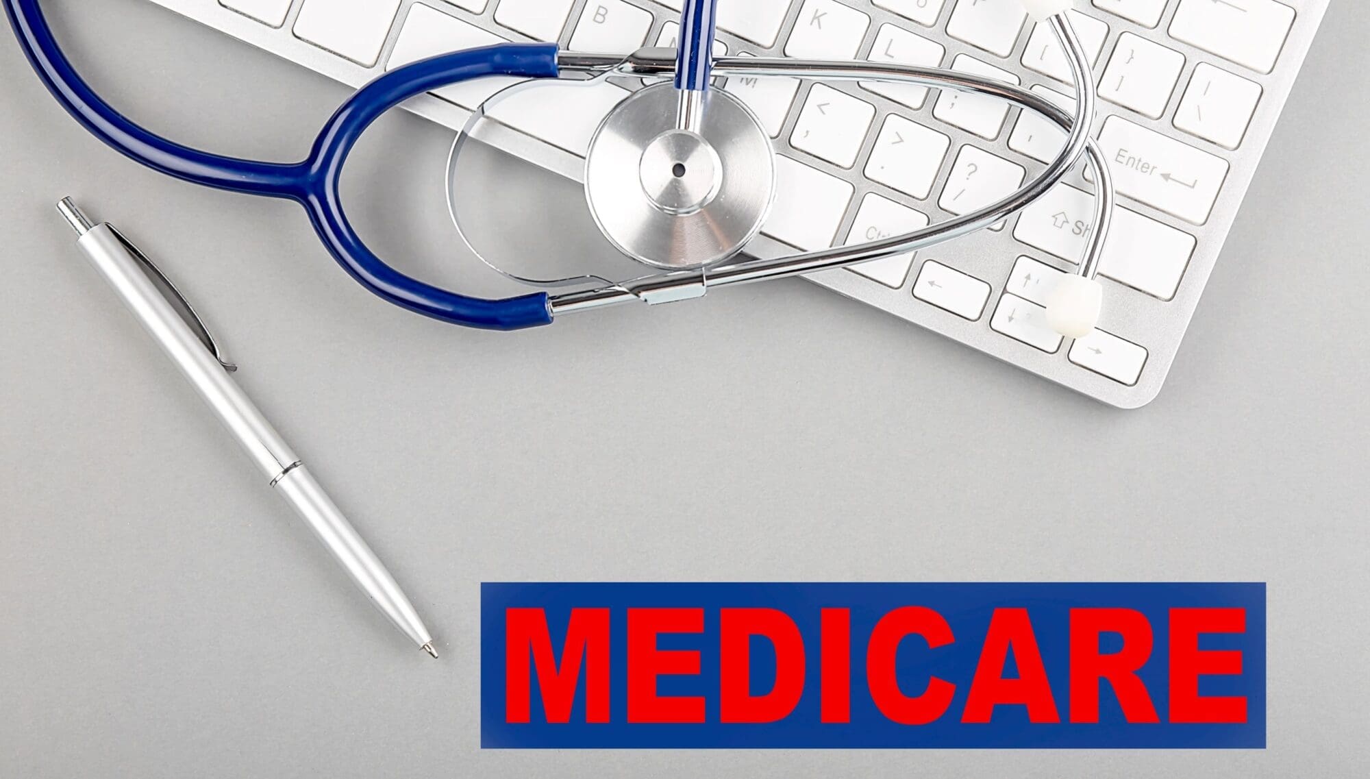Keyboard with a stethoscope and the word 'Medicare,